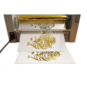 Toner foil laminator with gold foil and a tiger design transferred onto paper